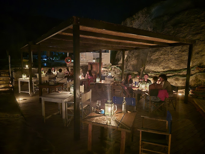 Unique cave restaurant in Ponza carved into the rock with tables overlooking the sea
