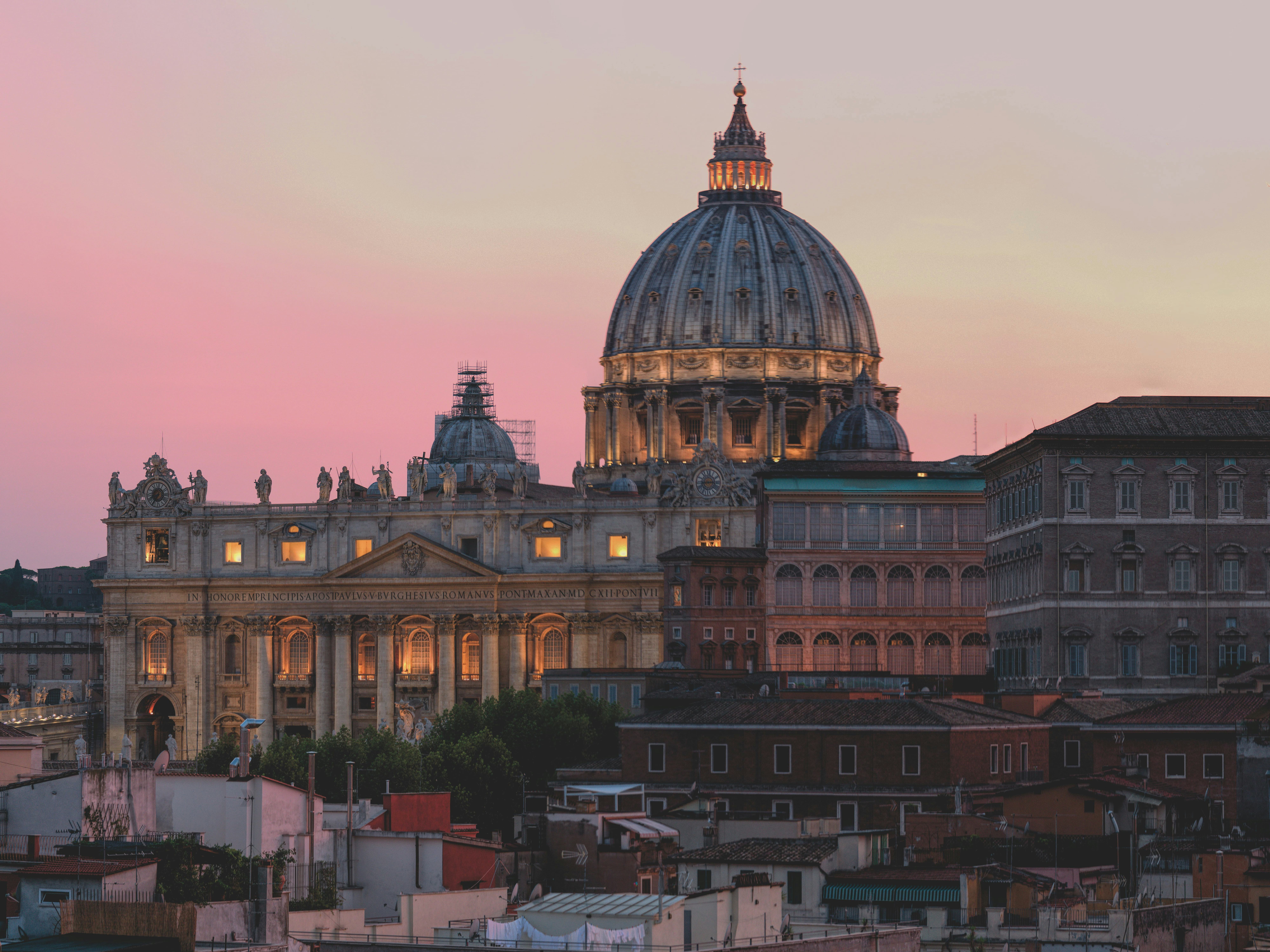 St. Peter's Basilica at sunset with golden light illuminating the dome