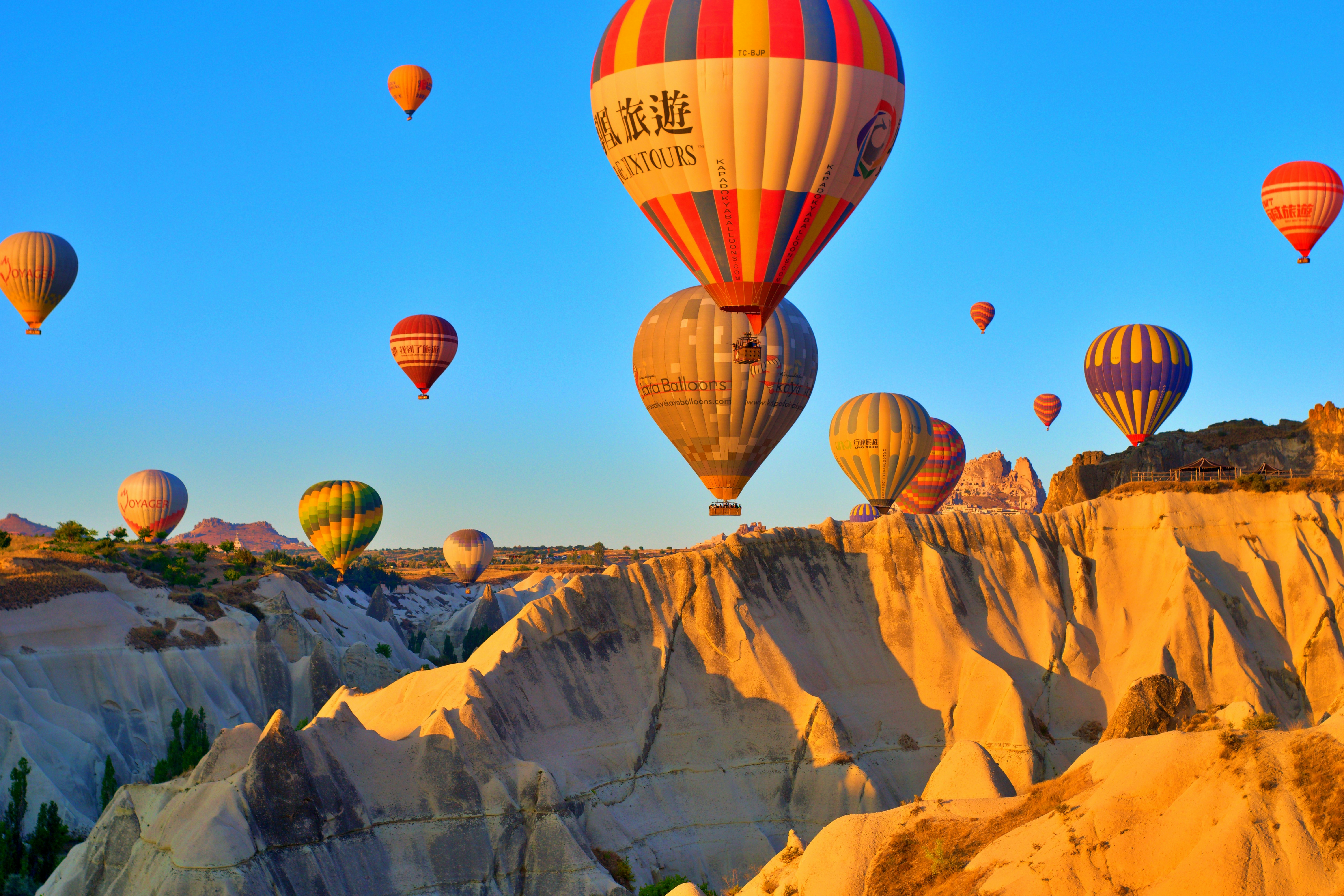 Hot air balloons floating over Cappadocia's unique rock formations at golden hour