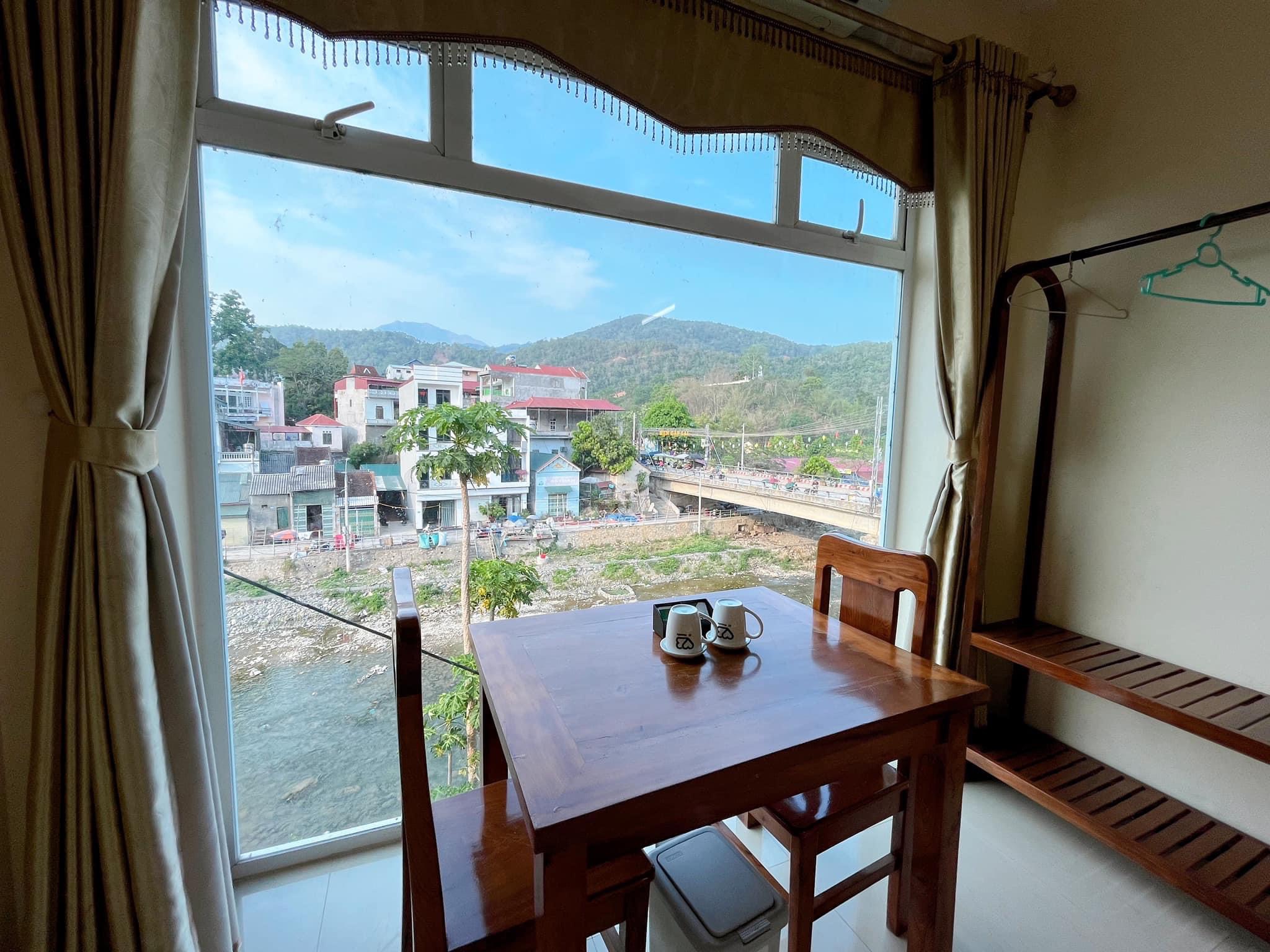 Riverside view from accommodation with mountains in the background