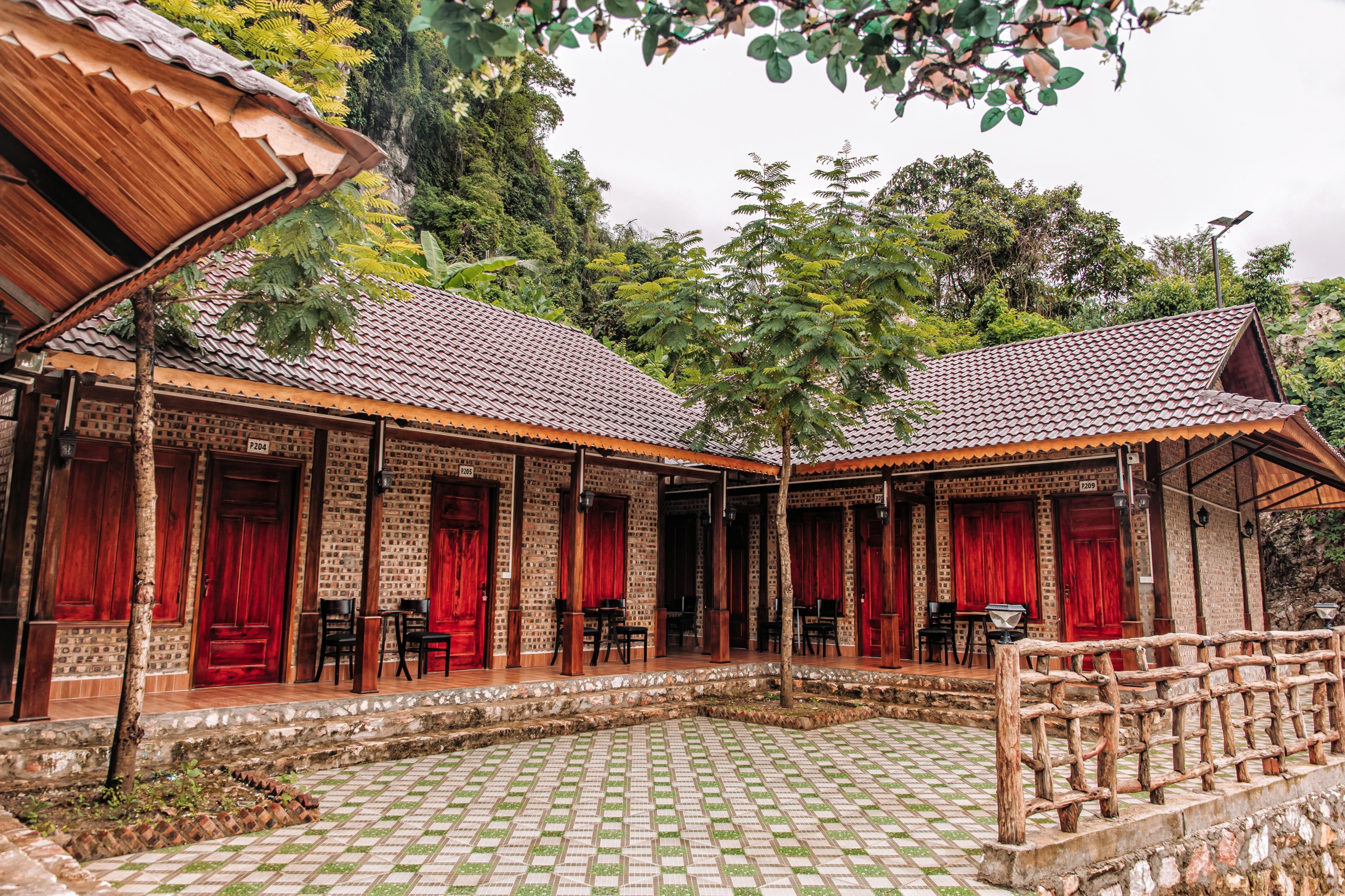 Traditional style lodging with red doors and brick walls